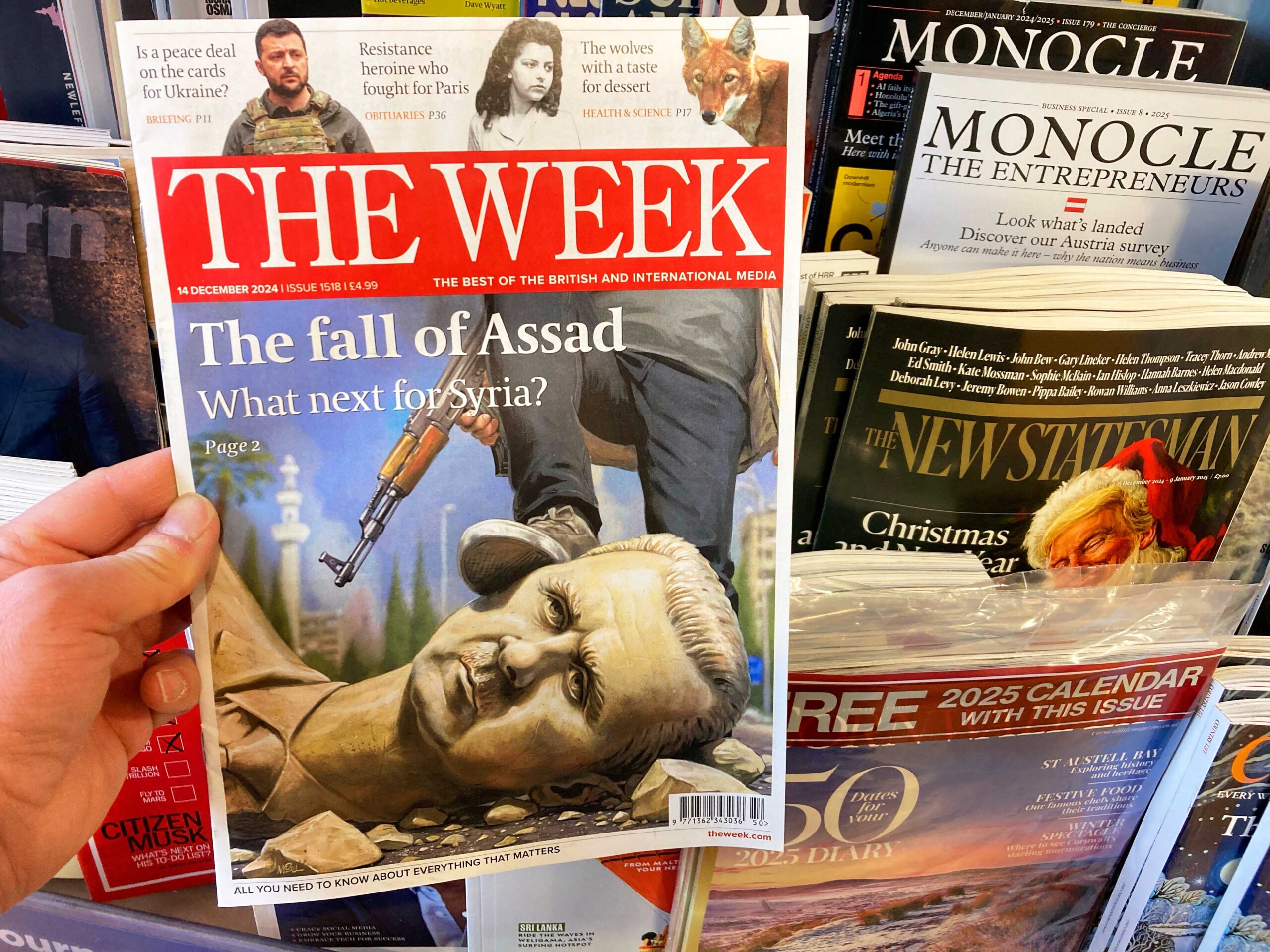 Magazine covers at a newspaper stall, featuring the fall of Assad.