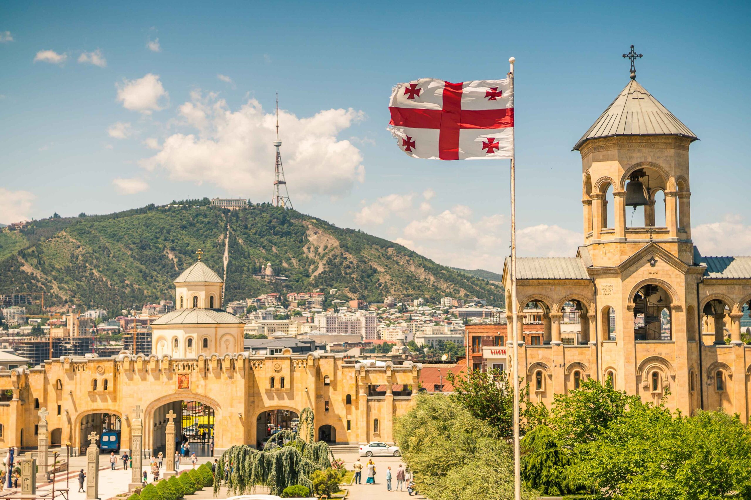 View of Tbilisi, Georgia with a Georgian flag on a pole.