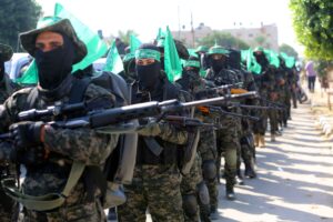 Hamas militants standing with rocket launchers in their hands.