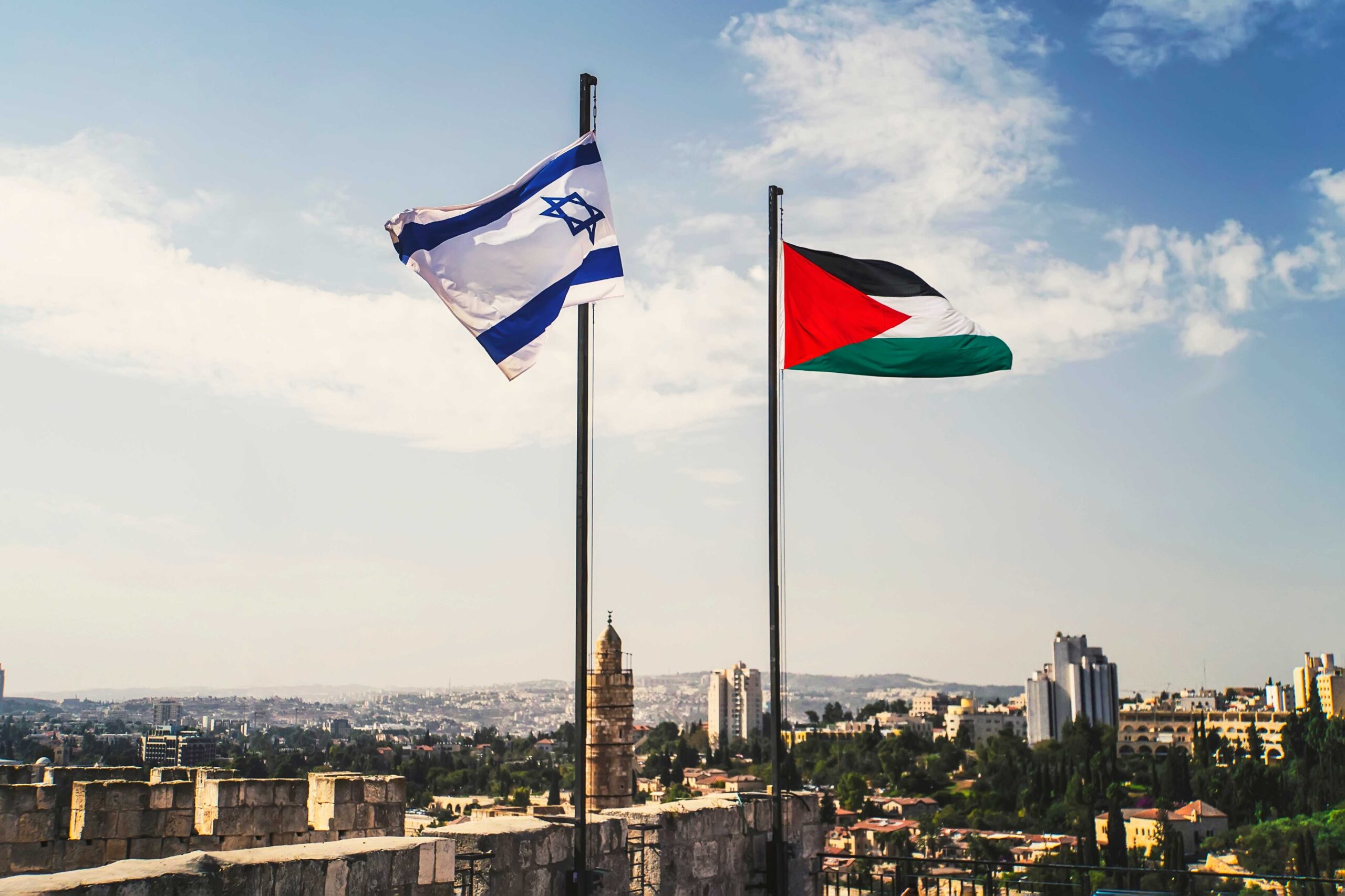 Flags of Palestine and Israel against sky and old Jerusalem. Two States for two peoples. Two-state solution concept.