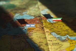 Flags of Israel and Iran over the map of the Middle East.