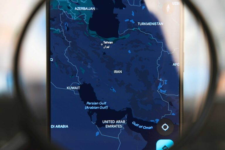 Magnifying glass over the map of Iran.