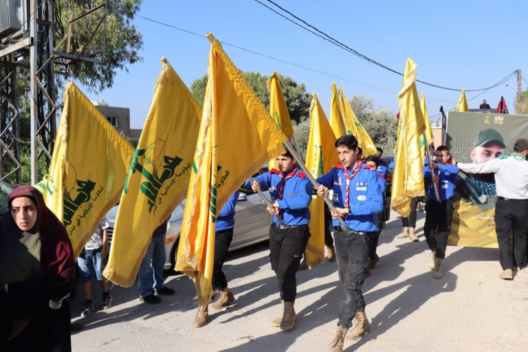 Hezbollah scouts carry the yellow party flag during a fighter’s funeral in southern Lebanon on June 21, 2025. The ceremony drew local supporters.