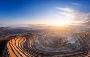 Panoramic of open pit mine industry, aerial view. Big yellow mining truck for coal working in quarry.