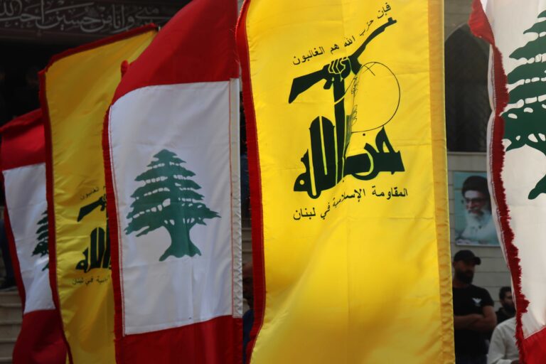 Tyre, South Lebanon – October 26, 2025: Lebanese and Hezbollah flags wave together during a public gathering.