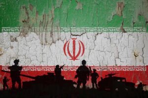 Iran flag painted on the cracked wall and soldiers shadow.