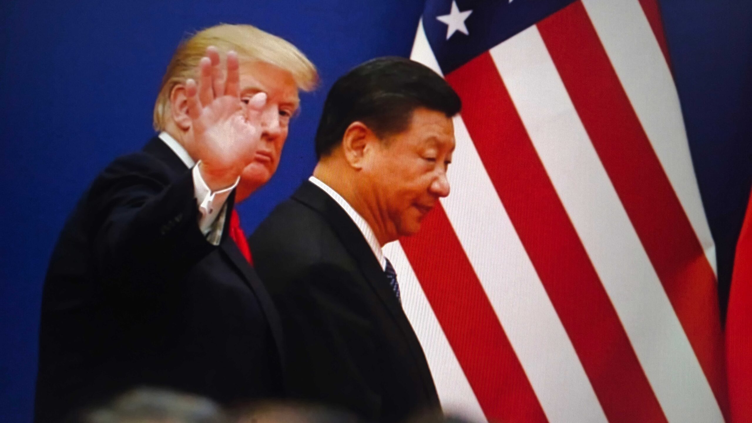 Donald trump and xi jinping stand together in front of the american and chinese flags, symbolizing international relations and diplomacy, New York City, October 7, 2025
