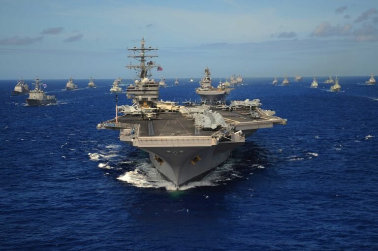 The Nimitz-class aircraft carrier USS Ronald Reagan leads a mass formation of ships from Korea, Taiwan, Japan, Singapore, France, Canada, Australia and the USA.