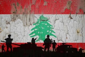 Lebanon flag painted on the cracked wall and soldiers shadow.