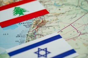 Close-up of the flags of Lebanon and Israel on a map of the Lebanon–Israel region.