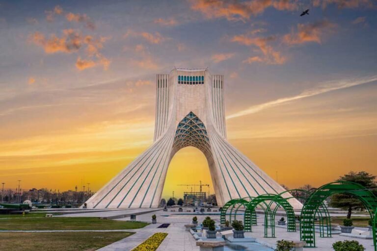 At sunset, locals enjoy a leisurely evening at this iconic landmark in Tehran, the capital of Iran. Azadi Towers, Iran.