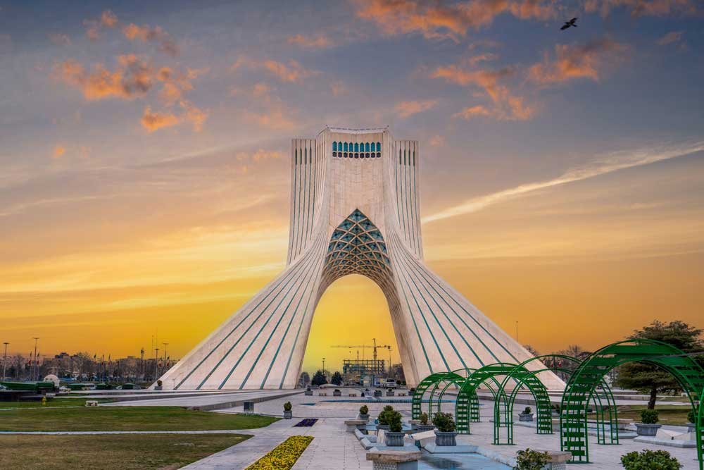 At sunset, locals enjoy a leisurely evening at this iconic landmark in Tehran, the capital of Iran. Azadi Towers, Iran